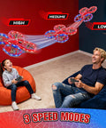 Man and girl playing with Spider Drones for Kids and Adults With 360 Degree Flips and Toss Launch 2 4Ghz Remote Auto Hover Obstacle Avoidance LED Lights Indoor Outdoor RC Quadcopter for Boys and Girls Beginners and Pros indoors on beanbags showcasing high, medium, and low speed modes.