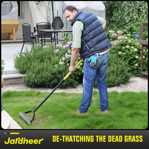 Man using Long Handle Thatch Rake For Lawns With Adjustable Head Manual Dethatcher For Dead Grass Removal And Lawn Debris