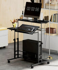 Electric adjustable standing desk featuring a built in power hub with dual USB ports and a rolling storage shelf in black finish.