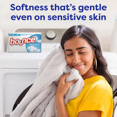 Woman smiling, holding soft blanket with Unscented Dryer Sheets 240 Count For Sensitive Skin Hypoallergenic Dermatologist Tested in background.