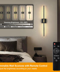 30 Inch Battery Powered Wall Sconces Set Of Two With Remote Dimmable LED Lighting In Black And Brushed Gold Finish displayed in bedroom.