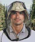 Man wearing Shielding Bugproof Mesh Head Net And Protective Headwear For Outdoorsy Folks Who Love Fishing Camping And Hiking Lakeside Adventures Keeps Bugs Out And Breathes Easy in forest