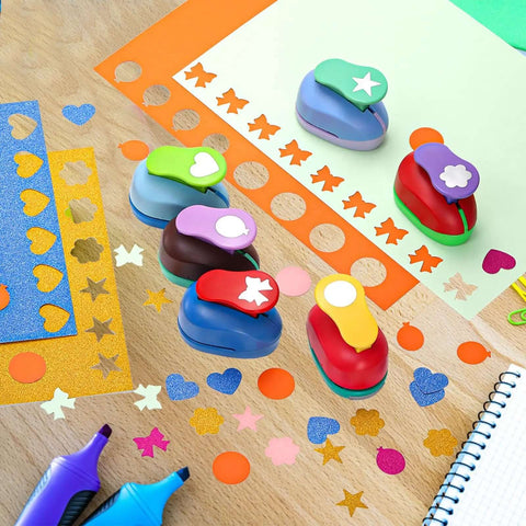 Six Shape Hole Punch Set For Kids 1 Inch Shape Punches on table with cardstock sheets for scrapbooking and DIY crafts