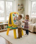 Kids drawing on a Mega Size Magnetic Double Sided Kids Easel Built Tough For Endless Creative Sessions with colorful designs.