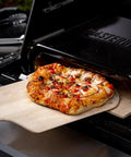 Gravity Series Outdoor Pizza Oven Accessory Insert With Ceramic Stone And Stainless Interior, Porcelain-Coated Exterior In Black Cooking Pizza