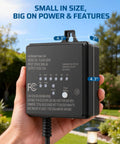 Hand holding Outdoor Low Voltage Transformer 60W 120V AC To 12V DC With Dusk To Dawn Sensor for LED landscape lighting in backyard.