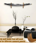 Two Pack Dope Sword Wall Mount Holder Kit For Katana Display in living room, wooden mounts holding samurai sword, brown finish