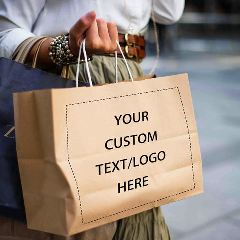 Person holding Logo Ready Printed Kraft Paper Bags 100 Pack With Handles 12.6 X 4.3 X 9.8 Inches Brown Gift Bags For Branding