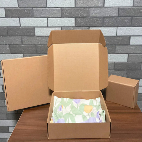 Heavy Duty 20 Pack Of 10X10X3 Inch Brown Corrugated Cardboard Shipping Boxes with smooth finish edges opened on a table.