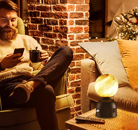 Cozy living room setting with Small Touch Bedside Table Lamp with USB Port and Outlet glowing beside man on chair.