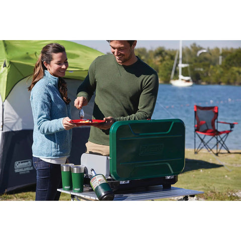Couple enjoying outdoor meal with Enamel Dinnerware Set For Outdoor Dining, 24-Piece Camp Kitchen Includes Plates Mugs Bowls And Silverware