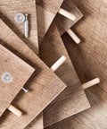 Wooden dowel pins set, 200 pcs, nine sizes with tapered beveled ends and fluted grooves, inserted in wooden boards for diy projects