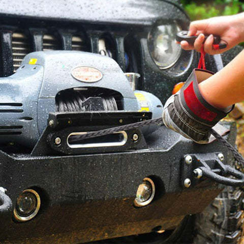 Person operating winch with Beefed Up Heavy Duty Synthetic Winch Rope Three Eighths Inch Diameter Ninety Two Feet Long For 25000 Lb Recovery With Hook on a Jeep