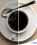 Cup of coffee with a spoon on a white plate, showcasing Sweet Sip Water Filter Cartridges For Coffee Machines.