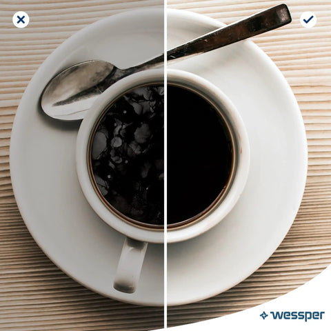 Cup of coffee with a spoon on a white plate, showcasing Sweet Sip Water Filter Cartridges For Coffee Machines.