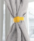 Ditch The Cord Chaos And Snag These Ridiculous 100 Piece Reusable Nylon Cable Ties Color Coded Wire Organizers For Zero Stress Tech Setup And Clean Workspace Storage. Yellow nylon tie securing gray curtain.