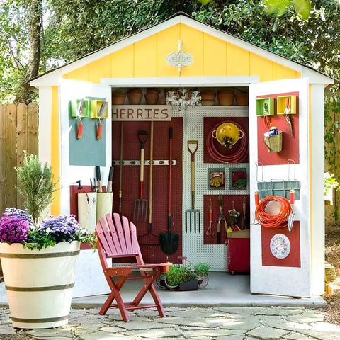 Shed interior with tools on wall and plants outside, featuring Metal Pegboard Organizer Kit For Walls 2 Pack 15.7 Inches By 15.7 Inches Gray Heavy Duty Shed Garden Storage System For Tools And Craft Gear DIY Friendly And Garage Ready Wall Mount Setup In The Garage Or Workshop.