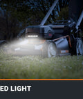 Nitro 21 Inch Cordless Lawn Mower with Self Propelled Drive featuring LED lights on a nighttime lawn, showing IntelliCut technology.