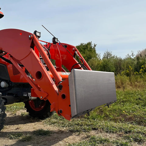 Five Sixteenth Inch Skid Steer Mount Plate Quick Attach Loader Plate on Kubota Tractor in a field