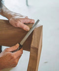 Craftsman using Heavy Duty Eight Inch Flat Hand Rasp Engineered With Tungsten Carbide Coating on wood for shaping.