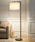 Modern LED Floor Lamp With Tan Fabric Shade Tall Corner Pole Standing Light For Living Rooms And Offices Ideal Bedroom Reading Light Black Finish in corner, illuminating room.