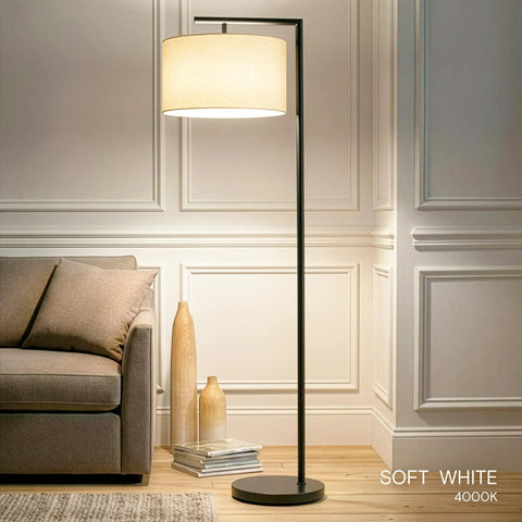Modern LED Floor Lamp With Tan Fabric Shade Tall Corner Pole Standing Light For Living Rooms And Offices Ideal Bedroom Reading Light Black Finish in corner, illuminating room.
