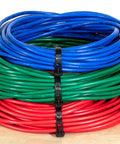 Heavy Duty 12 Inch Black Releasable Cable Ties 100 Pack Nylon 66 Zip Ties organizing blue, green, and red cables on a wooden surface.