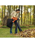 Person using 3 In 1 Corded Leaf Blower Vacuum Mulcher With 230 MPH Airflow And 12 Amp Motor for yard cleanup