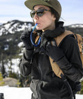 Hiker using Hydration Tube Replacement Kit For Hoser System With Self Sealing HyFLO Bite Valve on snowy trail
