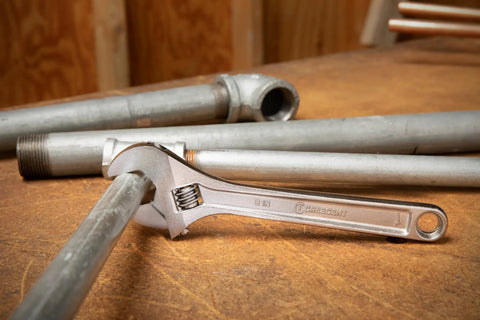 Alt Tag: 8 Inch Adjustable Wrench With Hex Jaw For Zero Slip Gripping, Chrome Plated Carded Hand Tool in use on metal pipe