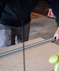 Person using Aluminum Pro Grip Clamp Straight Edge Wood Cutting Guide For Table Saw Up To 50 Inches for a precise cut