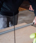 Person using Dead On Aluminum Straight Edge Guide For Table Saw And Router Jig With Heavy Duty Grip Clamp And 24 Inch Fence on wood.