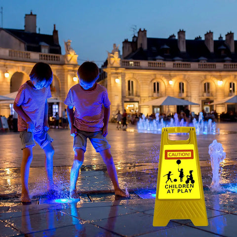 Kids playing near a fountain at night with a Four Pack 24 Inch Slow Down Kids At Play Sign Reflective Double Sided Street Safety Sign