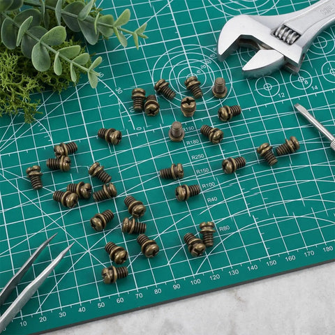 Rock Solid 30 Piece Full Replacement Ceiling Fan Blade Screws With 1/4-20 Threading And Premium Bronze Pan Heads on green grid surface.