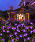 Purple Firefly Solar Lights Outdoor 2 Pack With 16 LEDs Waterproof Starburst Swaying Garden Path Lights illuminating a yard at night