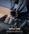 Gloved hand demonstrating the spring clasp feature of the Replacement Miter Saw Dust Bag For 7-1/4 And 8-1/2 Inch Saws With 1-1/2 Inch Dust Ports