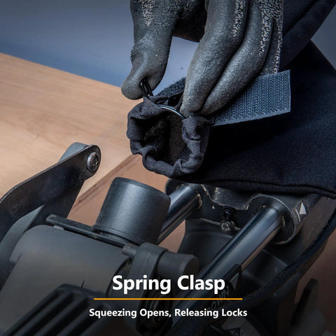 Gloved hand demonstrating the spring clasp feature of the Replacement Miter Saw Dust Bag For 7-1/4 And 8-1/2 Inch Saws With 1-1/2 Inch Dust Ports