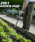 Person using 60 Inch Weed Puller With Long Handle, 2 In 1 Weed Rake And Garden Hoe to weed garden bed, showing tool in action.