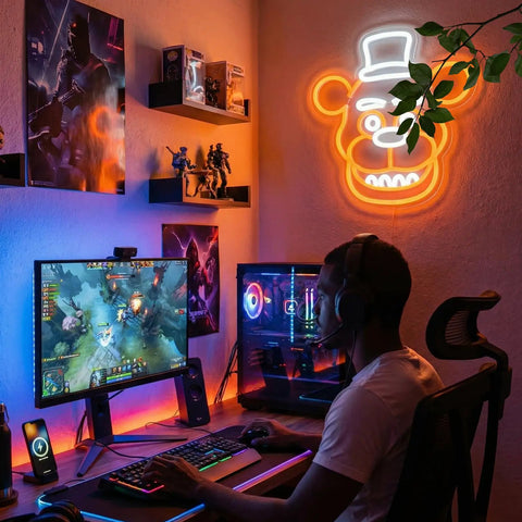 Frendy Neon Sign For Wall Decor With Remote Control glowing in game room setup with PC, orange bear design, LED lighting.