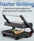 Chefman Indoor Grill Panini Press With Stainless Steel Finish And Nonstick Plates cooking chicken and asparagus on grill plates