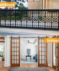 Outdoor view of black sliding gate and indoor sliding barn-style wooden doors with 6 Inch Heavy Duty Beefed Up Sliding Gate Roller Kit With L Bracket Universal Adjustable Gate Rollers Black Sliding Gate Guide Wheel Hardware For Barns Garages Sheds And Doors Easy Install.