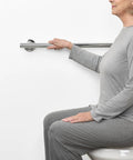 24 Inch Coronado Designer Straight Shower Grab Bar In Stainless Steel With Polished Chrome Finish Built For Easy Grip And Safe Bathroom Access Concealed Flange Mount For A Dope Spa Style Look shown in use by seated woman