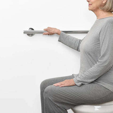 24 Inch Coronado Designer Straight Shower Grab Bar In Stainless Steel With Polished Chrome Finish Built For Easy Grip And Safe Bathroom Access Concealed Flange Mount For A Dope Spa Style Look shown in use by seated woman