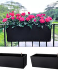 Super Sleek Two Pack Rail Planters For Balcony And Deck Twenty Inch Self Watering Garden Boxes In Matte Black with flowers on a railing.