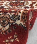 Close-up of Non Slip Stair Treads Set Of 13 Oriental Peel And Stick Alfombras in Bold Red, 8x30 inches on concrete floor.