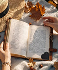 Genuine Leather Heart Page Corner Bookmarks For The Reading Crew Soft Grip Clips, colors over book with autumn leaves.