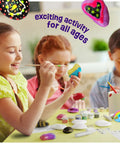 Children painting rocks with Glow In The Dark Rock Painting Kit For Kids Ages Six To Twelve Arts And Crafts Gift Set visible on table