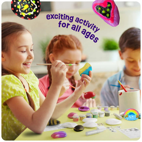 Children painting rocks with Glow In The Dark Rock Painting Kit For Kids Ages Six To Twelve Arts And Crafts Gift Set visible on table