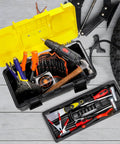 16 Inch Plastic Toolbox With Handle Portable Toolbox With Removable Tray And Lockable Design Built Tough For Home Workshop Or Garage With Small Parts Box In Black And Yellow, open with tools inside next to tire.