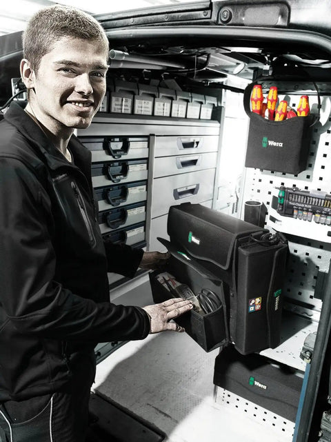 Man organizing tools in van with 2Go 4 Tool Quiver Compact Tool Belt Organizer visible among other tool storage solutions.